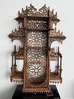 Full front view of ornate wooden wall shelf