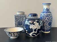 Front view of all four blue and white porcelain pieces