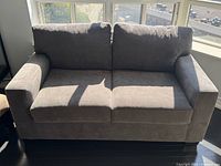Front view of grey two-seat sofa