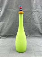 Full view of bottle standing upright with colourful stopper