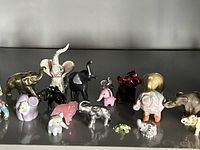 Full group of miniature animal figurines on shelf