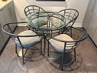 Overall view of glass table with four chairs