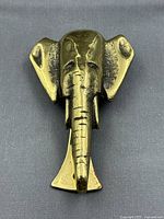 Front view of brass elephant head door knocker