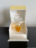 Open box showing perfume bottle with frosted dove stopper