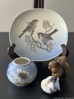 Group shot of plate, bud vase, dove figurine, squirrel figurine