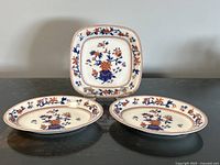 Group shot showing square dish and two oval bowls, pattern visible