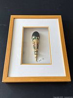 Frontal view of framed carving showing whole presentation