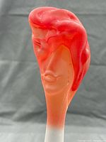 Front view of Fellerman frosted glass face stopper showing sculpted features and color gradient