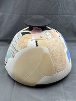 Front view of painted ceramic jar with lid