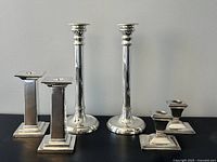 All three candlestick pairs standing
