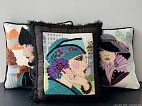 Front view of all three needlepoint portrait pillows