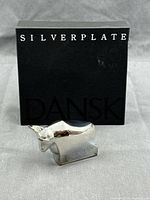 Bull paperweight in front of original box showing scale and finish