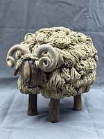 Full view of pottery sheep sculpture showing fleece texture and horns