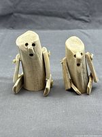 Front view of both antler figurines standing upright