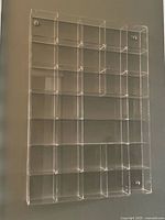 Front view of clear Lucite display case mounted on wall
