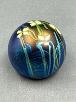 Front view of iridescent paperweight showing floral design