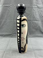 Full view of signed painted ceramic bottle with stopper showing artwork and condition