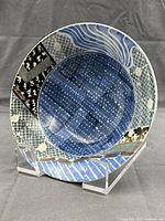 Front view of painted porcelain bowl on display stand