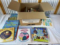 Open box with multiple children’s books visible around it