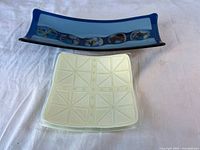 Top view of blue fused glass plate and white square dish