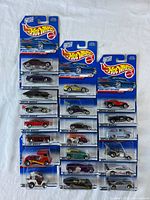 Front view of 21 carded Hot Wheels 1999 First Editions cars arranged in three columns