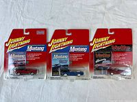 Overview of three sealed Johnny Lightning cars