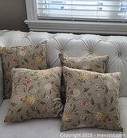 Four floral cushions on white sofa