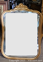 Front view of gold gilt wood mirror with shell crest