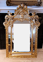Front view of ornate gilt wood wall mirror
