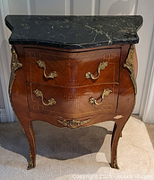 Front view of bombe side table showing drawers, ormolu mounts and overall condition