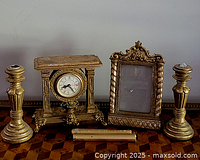 group shot showing all items: two candlesticks, clock, frame, cylinder