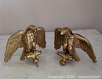 pair of brass eagle finials front view