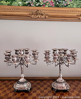 Full view of both silver-plated 9-light candelabras on table