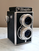 Front angled view showing body, lenses, focusing knob