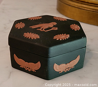 Closed hexagonal trinket box showing lid and side relief