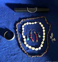 All jewellery items laid out on blue fabric