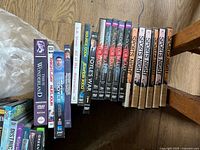 Spines of multiple TV series sets and box sets on floor, including Foyle’s War, Doctor Blake, Sports Night