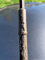 Metal socket joining blade to shaft showing vent holes and textured grip on shaft