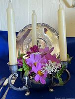 Candelabrum set up with candles/flowers in front of tray