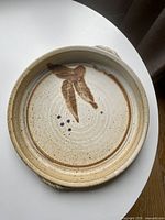 Top view of stoneware bowl showing glaze, decoration and handles