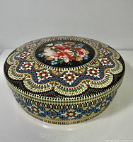 Full view of closed round tin showing lid design and side pattern
