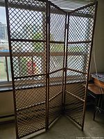 Room divider fully opened showing three lattice rattan panels