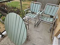 Table and two chairs unfolded on balcony