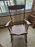 Front view of wooden spindle-back rocking chair
