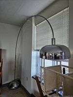 Full view of arc floor lamp beside window