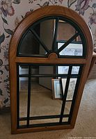Front view of arched wood-look mirror