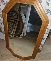Front view of octagonal teak framed mirror