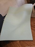 Top view of full size light blue speckled foam topper laid flat