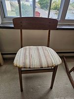 Front view of wood desk chair with striped upholstered seat