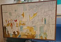 Front view of abstract mixed-media canvas in frame